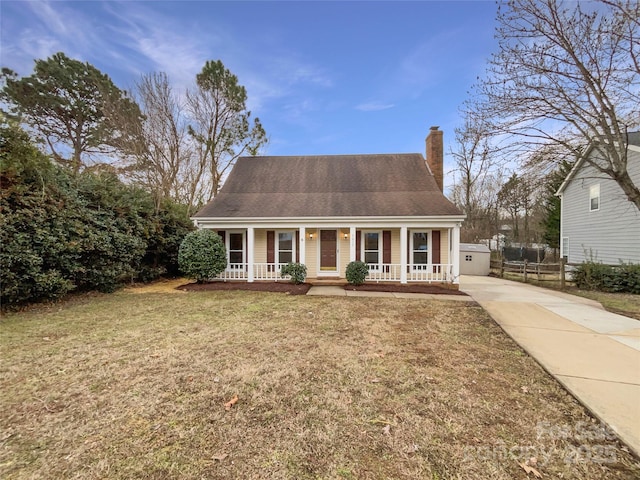 cape cod house with a porch and a front lawn