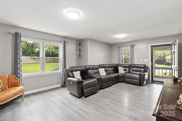 107 Deese Ct, Indian Trail, NC 28079 - living area featuring a textured ceiling, wood finished floors, and baseboards