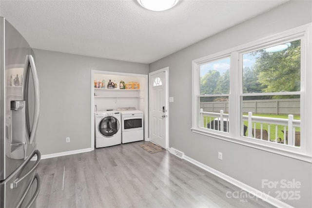 107 Deese Ct, Indian Trail, NC 28079 - laundry room with washer and clothes dryer, wood finished floors, a textured ceiling, and baseboards