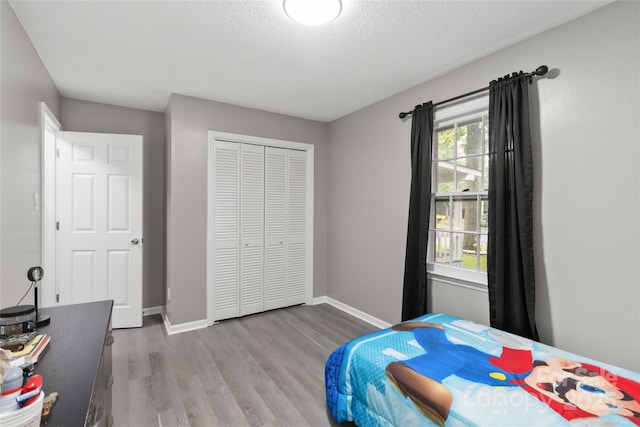 107 Deese Ct, Indian Trail, NC 28079 - bedroom featuring wood finished floors, baseboards, a closet, and a textured ceiling