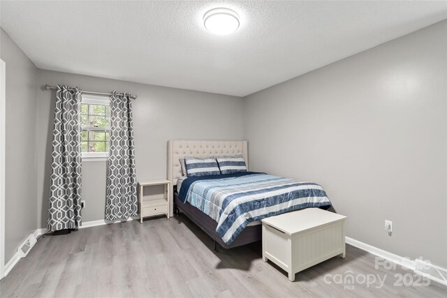 107 Deese Ct, Indian Trail, NC 28079 - bedroom featuring wood finished floors, baseboards, and a textured ceiling