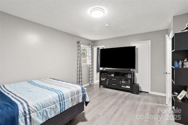 107 Deese Ct, Indian Trail, NC 28079 - bedroom featuring wood finished floors, baseboards, and a textured ceiling