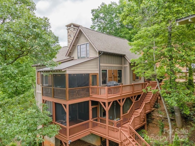 back of house featuring a sunroom and french doors