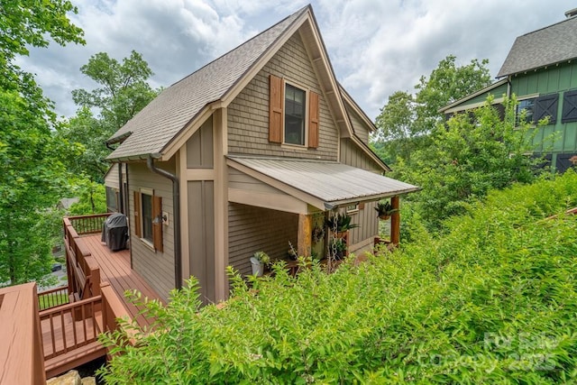 view of property exterior with a wooden deck