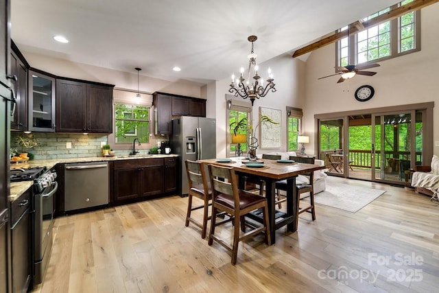 dining space with sink, light hardwood / wood-style floors, and a wealth of natural light