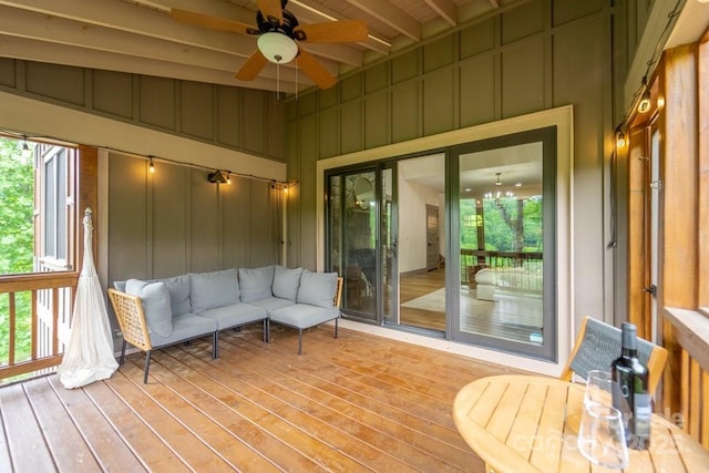 sunroom / solarium with beamed ceiling and ceiling fan