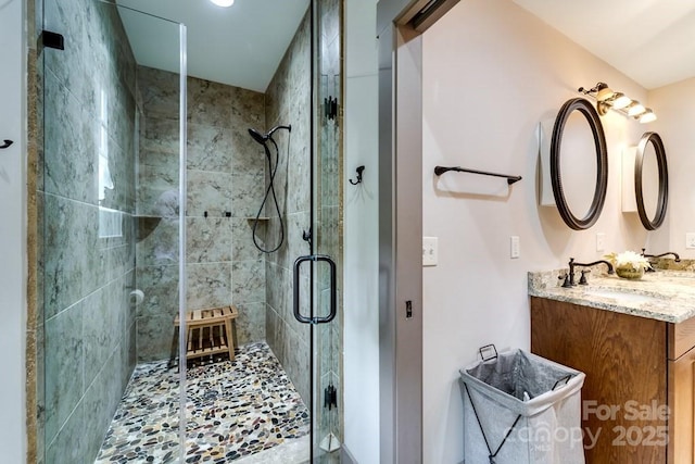 bathroom featuring an enclosed shower and vanity