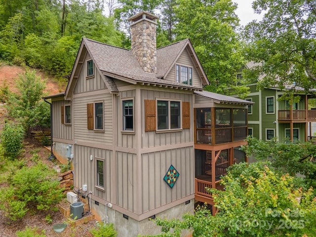 view of outdoor structure with a sunroom and cooling unit