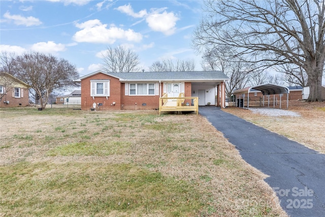 ranch-style house featuring a carport and a front lawn