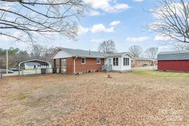 rear view of house with a yard and a carport