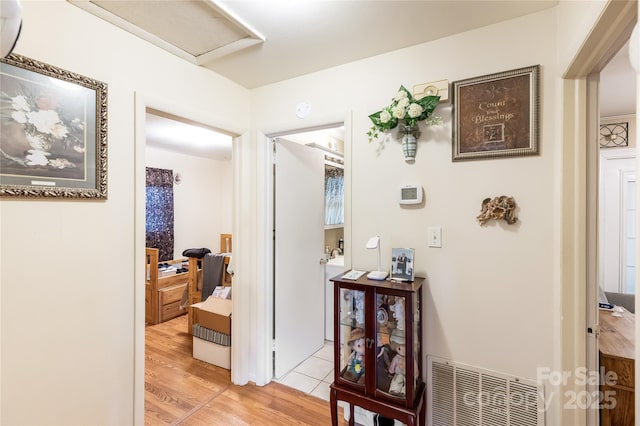 corridor with light hardwood / wood-style flooring