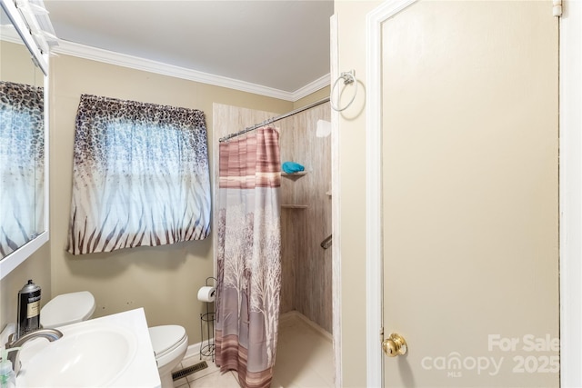 bathroom featuring sink, ornamental molding, toilet, and walk in shower