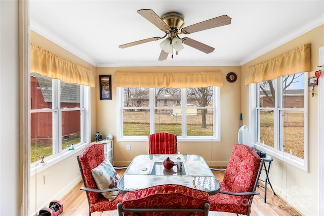 sunroom featuring ceiling fan and a healthy amount of sunlight