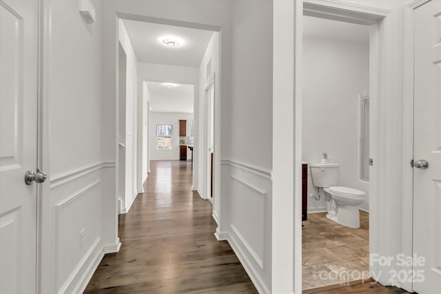 hallway with dark hardwood / wood-style floors