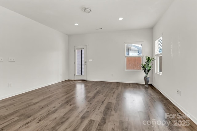 unfurnished room featuring dark hardwood / wood-style flooring