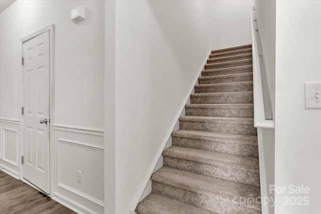 stairs featuring wood-type flooring