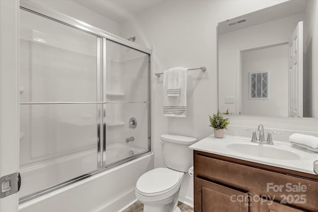 full bathroom with toilet, vanity, and enclosed tub / shower combo