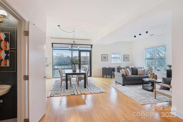 living room featuring a chandelier and light hardwood / wood-style floors