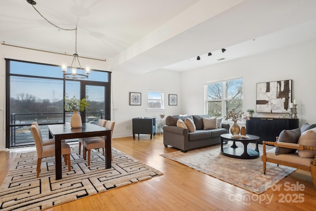 living room featuring light hardwood / wood-style flooring and a notable chandelier