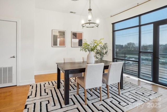 dining room with a notable chandelier and light hardwood / wood-style floors