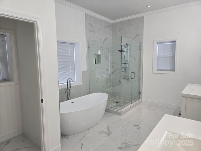 bathroom with marble finish floor, crown molding, a marble finish shower, vanity, and a freestanding tub