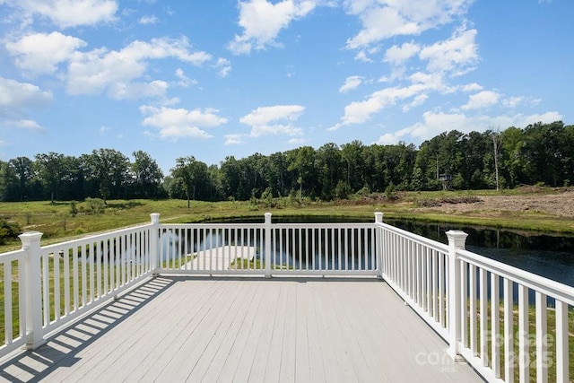 wooden terrace featuring a water view