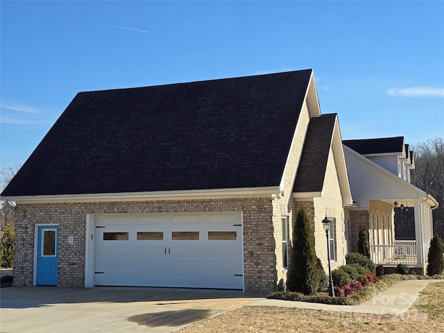 view of front facade featuring brick siding, driveway, an attached garage, and roof with shingles