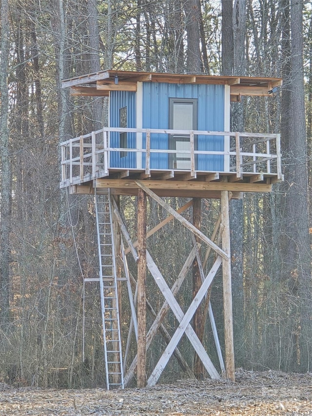 view of outbuilding featuring a forest view