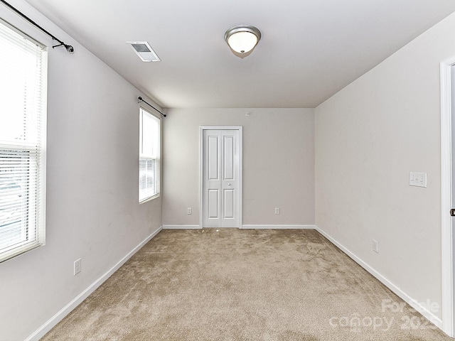 spare room with light colored carpet