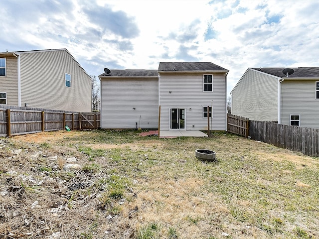 rear view of property with a yard and a patio