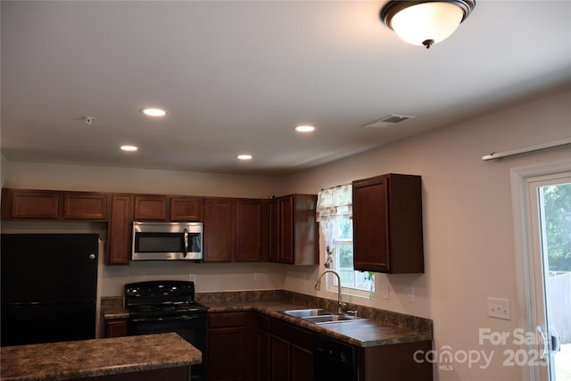 1128 Tangle Ridge Dr SE, Concord, NC 28025 - kitchen with black appliances, dark countertops, and recessed lighting