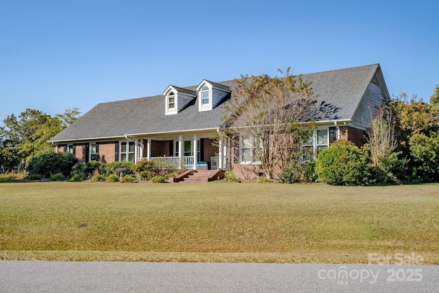 cape cod house with a porch and a front yard