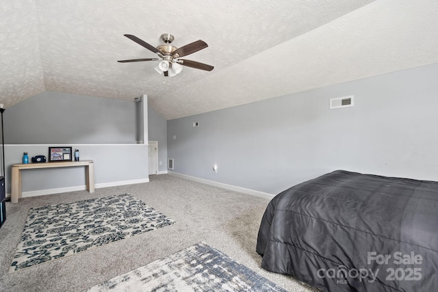 bedroom featuring ceiling fan, vaulted ceiling, a textured ceiling, and carpet flooring