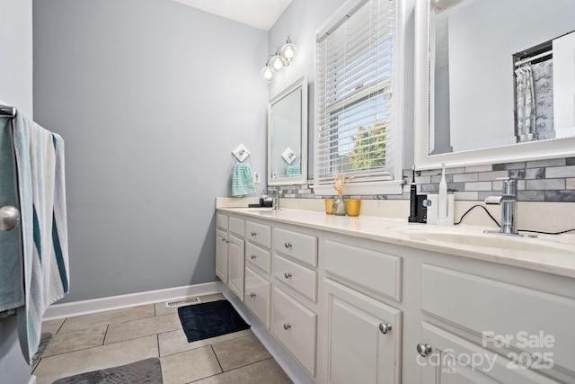 bathroom featuring tasteful backsplash, vanity, and tile patterned flooring