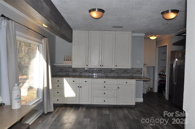 kitchen featuring dark hardwood / wood-style flooring, backsplash, white cabinets, and stainless steel refrigerator with ice dispenser