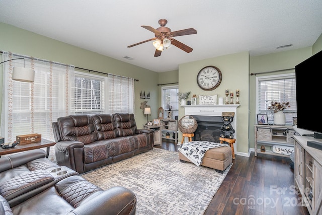 living room with plenty of natural light, dark hardwood / wood-style floors, and ceiling fan