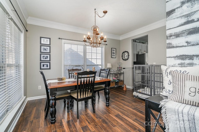 dining space featuring dark hardwood / wood-style flooring, crown molding, and a chandelier