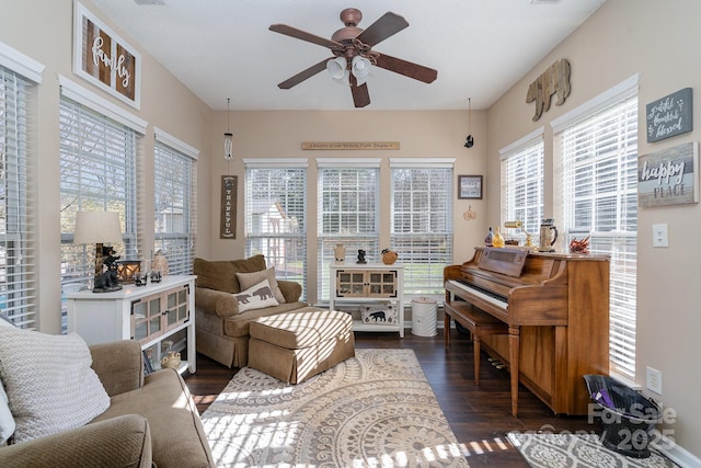 sitting room with dark hardwood / wood-style flooring and ceiling fan