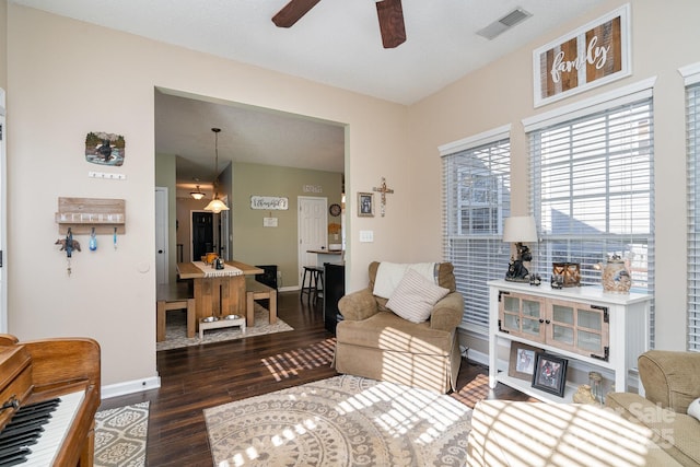 living room featuring dark hardwood / wood-style floors and ceiling fan