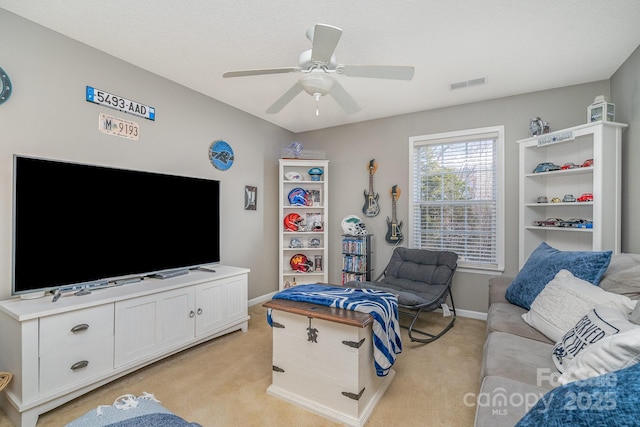 living room with ceiling fan and light colored carpet