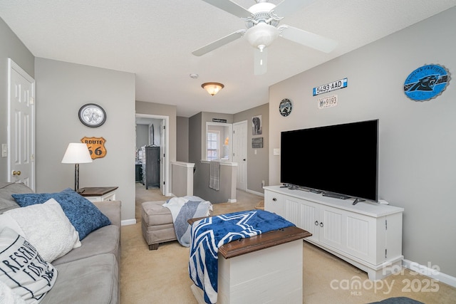 carpeted living room with a textured ceiling and ceiling fan