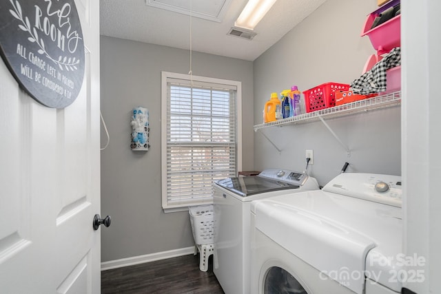 laundry area with dark wood-type flooring, independent washer and dryer, and a textured ceiling