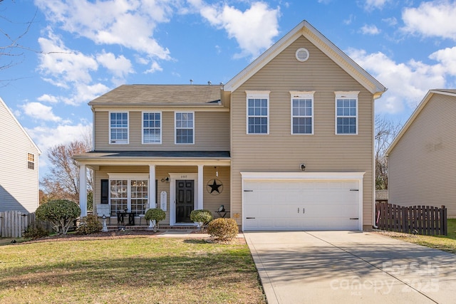 view of property with a garage, covered porch, and a front yard