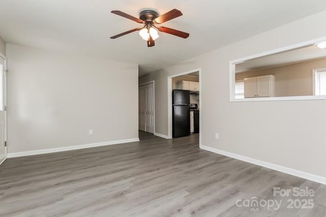 unfurnished room featuring hardwood / wood-style flooring and ceiling fan