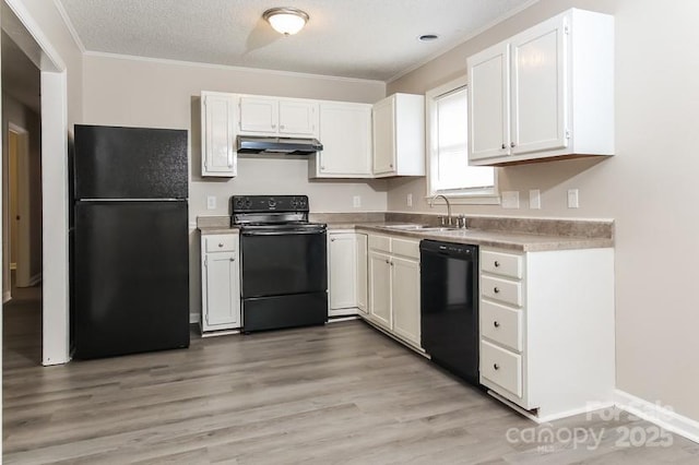 kitchen featuring white cabinetry, sink, black appliances, crown molding, and light hardwood / wood-style flooring