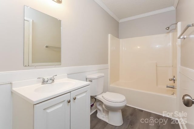 full bathroom featuring toilet, crown molding, shower / tub combination, vanity, and hardwood / wood-style flooring