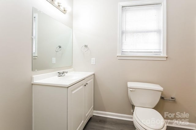 bathroom with vanity, hardwood / wood-style floors, and toilet