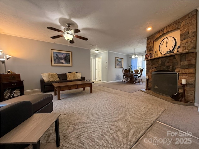 carpeted living room featuring crown molding, a stone fireplace, ceiling fan, and a textured ceiling