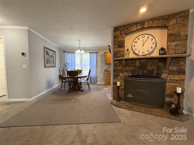 carpeted dining room featuring a stone fireplace, ornamental molding, a chandelier, and a textured ceiling