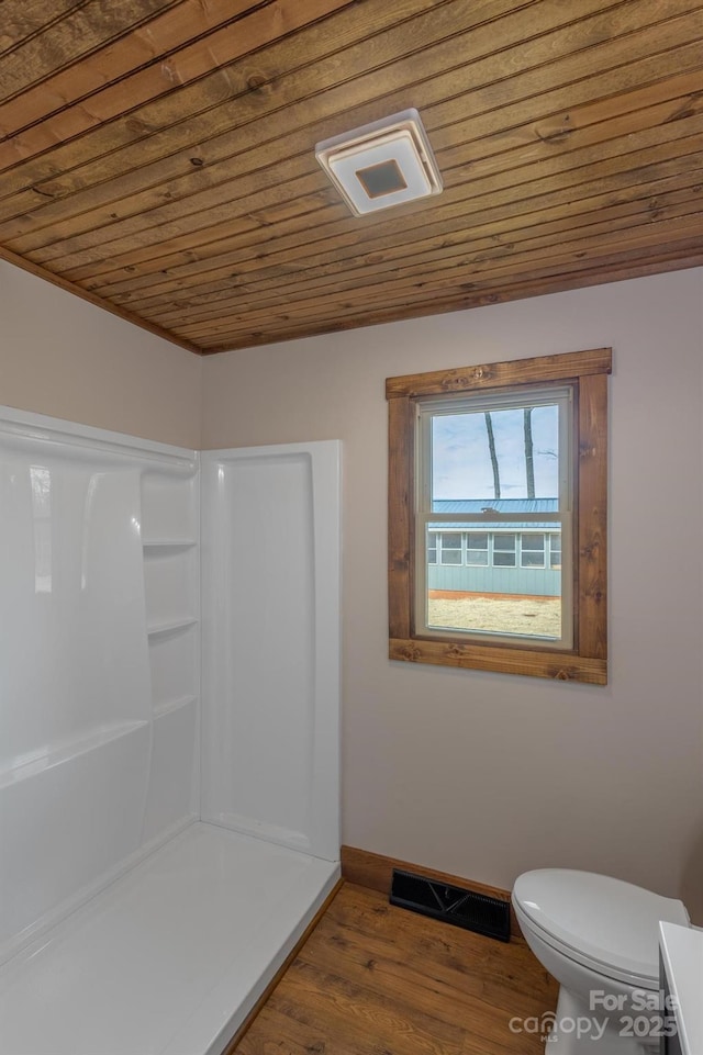 bathroom featuring wood-type flooring, wooden ceiling, toilet, and a shower